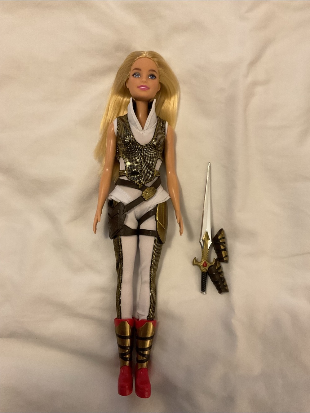 Barbie wearing MOTU Teela Doll outfit in White and Gold Outfit with Red Boots